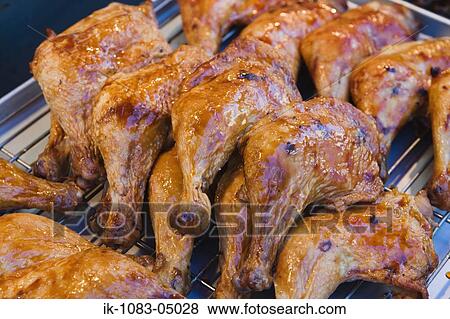 Barbecued chicken legs being cooked on grill View Large Photo Image Stock Photo - Barbecued chicken legs being cooked on grill. Fotosearch