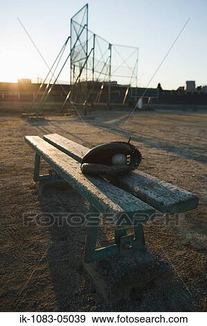 Baseball glove with ball in wooden bench View Large Photo Image Stock Photo - Baseball glove with ball in wooden bench. Fotosearch