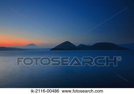 Stock Photograph - Beautiful seascape with mountains at sunset. Fotosearch