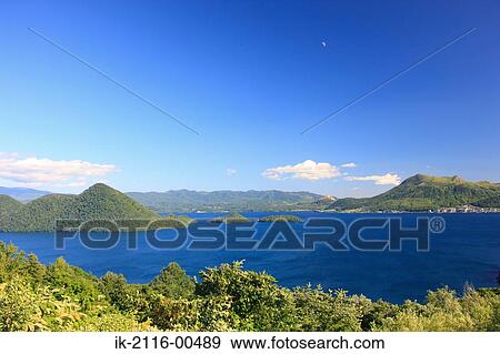 Stock Photo - Beautiful view of sea with mountains at moonrise. Fotosearch