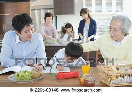 Stock Photo - Boy doing homework with his family. Fotosearch