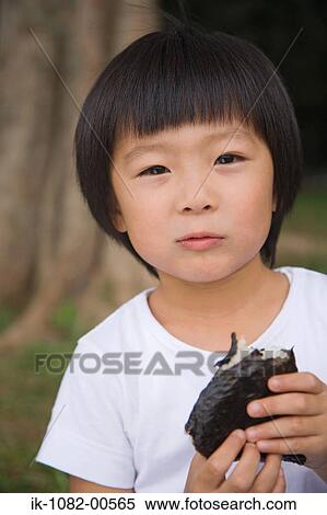 Boy eating chocolate cake and looking at camera View Large Photo Image Stock Photography - Boy eating chocolate cake and looking at camera. Fotosearch