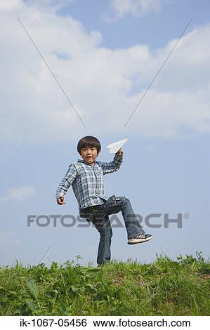 Boy holding paper airplane View Large Photo Image Stock Photograph - Boy holding paper airplane. Fotosearch