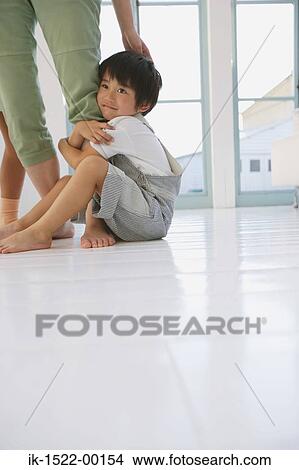 Picture - Boy Hugging Mother's Leg. Fotosearch