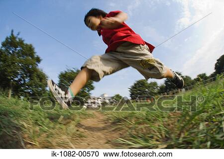 Boy running in park View Large Photo Image Stock Image - Boy running in park. Fotosearch