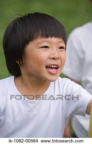 Boy speaking and standing outdoors View Large Photo Image Picture - Boy speaking and standing outdoors. Fotosearch