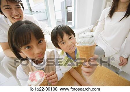 Stock Photo - Brother and Sister Enjoying Ice Cream Cones. Fotosearch