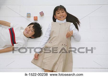 Stock Photo - Brother and Sister Laying Down. Fotosearch