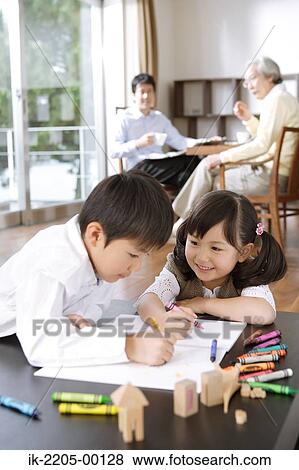 Stock Photo - Brother and sister painting in dining room. Fotosearch