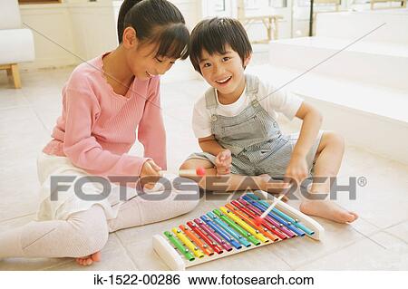 Brother and Sister Playing with Xylophone View Large Photo Image Stock Photograph - Brother and Sister Playing with Xylophone. Fotosearch