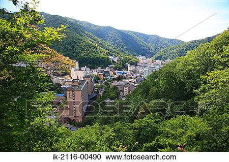 Stock Image - Buildings surrounded with trees on hillside. Fotosearch