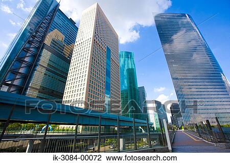 Stock Image - Buildings with bridge and walkway in urban city. Fotosearch
