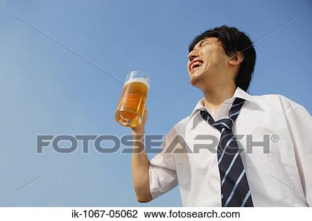 Stock Image - Businessman Holding a Beer. Fotosearch