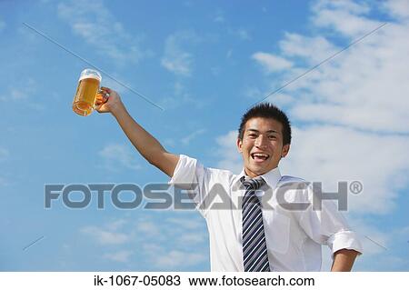 Businessman Holding a Beer View Large Photo Image Stock Image - Businessman Holding a Beer. Fotosearch