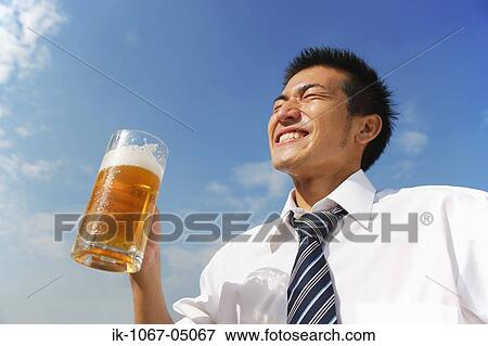 Businessman Holding a Beer View Large Photo Image Stock Photo - Businessman Holding a Beer. Fotosearch