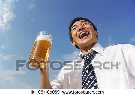 Stock Photo - Businessman Holding a Beer. Fotosearch