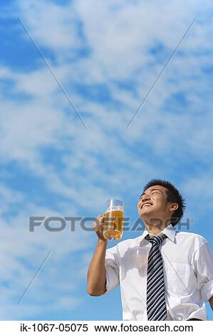 Businessman Holding a Beer View Large Photo Image Stock Photography - Businessman Holding a Beer. Fotosearch