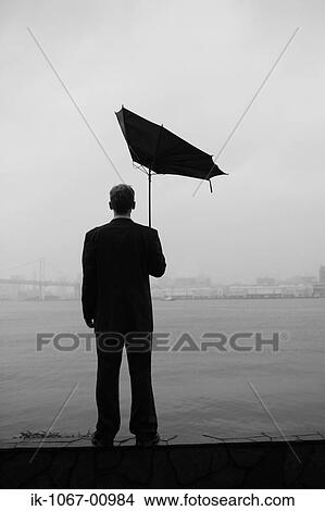 Picture - Businessman Looking out into Port. Fotosearch
