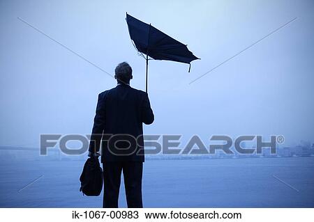 Stock Image - Businessman Looking out into Port. Fotosearch