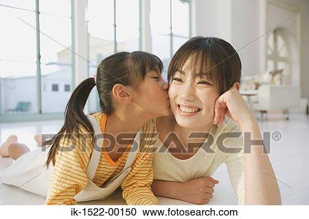 Stock Image - Child Kissing Mother. Fotosearch