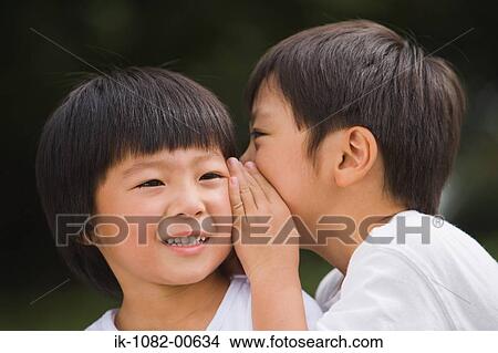 Child sharing secret with his friend View Large Photo Image Picture - Child sharing secret with his friend. Fotosearch