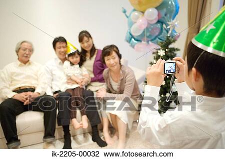 Child taking snap of his family View Large Photo Image Stock Image - Child taking snap of his family. Fotosearch