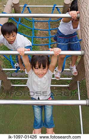 Children climbing on climbing frame a park View Large Photo Image Stock Photograph - Children climbing on climbing frame a park. Fotosearch