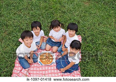 Children enjoying eating pizza View Large Photo Image Stock Photo - Children enjoying eating pizza. Fotosearch