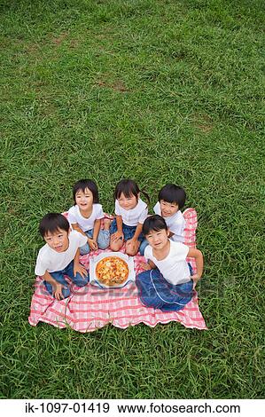 Children enjoying eating pizza View Large Photo Image Stock Photo - Children enjoying eating pizza. Fotosearch