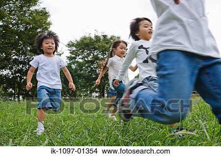 Children enjoying in a park View Large Photo Image Picture - Children enjoying in a park. Fotosearch