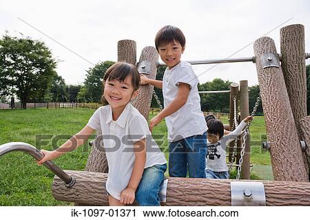 Children playing on jungle gym in a park View Large Photo Image Stock Image - Children playing on jungle gym in a park. Fotosearch
