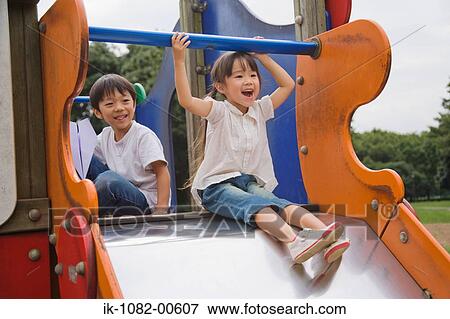 Children playing on slide in a park View Large Photo Image Stock Photo - Children playing on slide in a park. Fotosearch