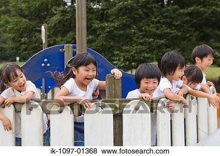Children playing together in a park View Large Photo Image Stock Photo - Children playing together in a park. Fotosearch
