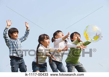 Children playing together with a ball View Large Photo Image Stock Image - Children playing together with a ball. Fotosearch