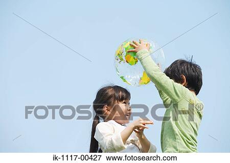 Children playing together with a ball View Large Photo Image Stock Photo - Children playing together with a ball. Fotosearch