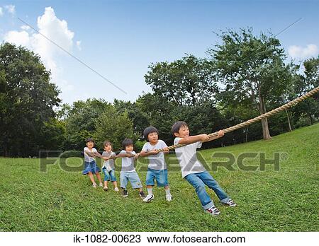 Children playing Tug-Of-War in park View Large Photo Image Stock Image - Children playing Tug-Of-War in park. Fotosearch