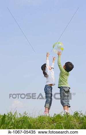 Children playing with ball in park View Large Photo Image Stock Photography - Children playing with ball in park. Fotosearch