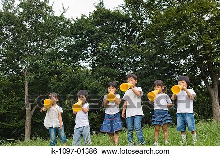 Children playing with megaphones in a park View Large Photo Image Stock Photograph - Children playing with megaphones in a park. Fotosearch