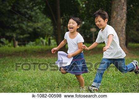 Stock Photo - Children running in park together. Fotosearch
