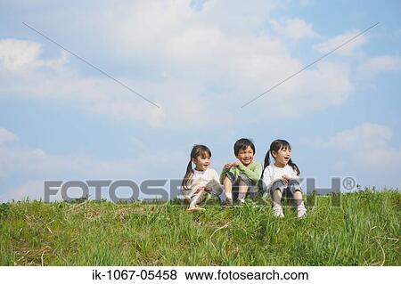Children sitting in park together View Large Photo Image Stock Photo - Children sitting in park together. Fotosearch