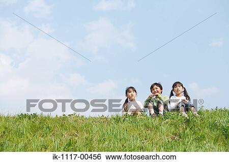 Children sitting in park together View Large Photo Image Stock Photograph - Children sitting in park together. Fotosearch