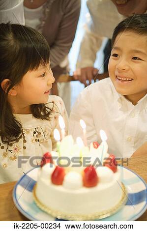 Children standing with birthday cake View Large Photo Image Picture - Children standing with birthday cake. Fotosearch