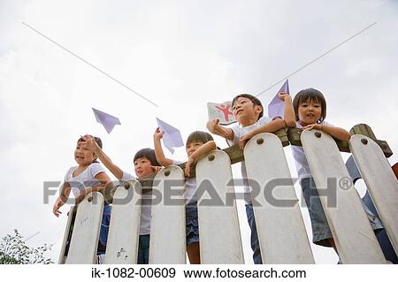 Children throwing paper aeroplanes View Large Photo Image Stock Photo - Children throwing paper aeroplanes. Fotosearch