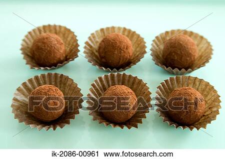 Stock Image - Chocolate Truffle on Green Background. Fotosearch