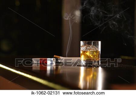 Cigarette pack, scotch-whiskey, lit cigarette in ashtray View Large Photo Image Stock Image - Cigarette pack, scotch-whiskey, lit cigarette in ashtray. Fotosearch