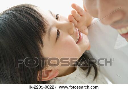 Daughter whispering in her father ears View Large Photo Image Stock Photo - Daughter whispering in her father ears. Fotosearch