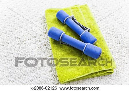 Stock Photograph - Dumbbells lying on towel. Fotosearch