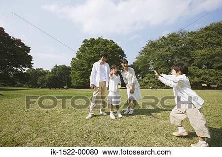 Stock Image - Family Blowing Bubbles. Fotosearch