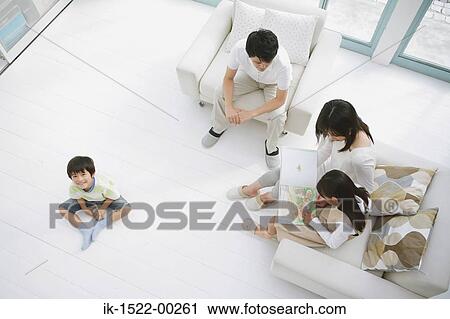 Stock Image - Family in Living Room. Fotosearch