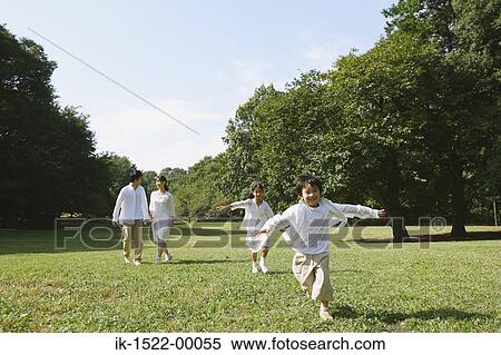 Stock Photography - Family in Park, Children Running Around. Fotosearch